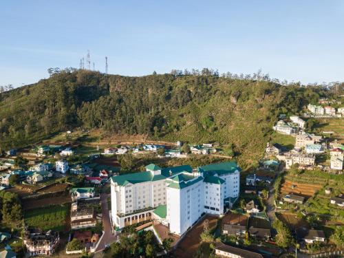 an aerial view of a city with a mountain at Araliya Red - Budget friendly Hotel- Where you find stunning 360 panoramic view of Nuwara Eliya in Nuwara Eliya