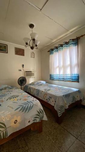 1 Schlafzimmer mit 2 Betten und einem Fenster in der Unterkunft Hospedaje el viejo y el mar in El Pájaro