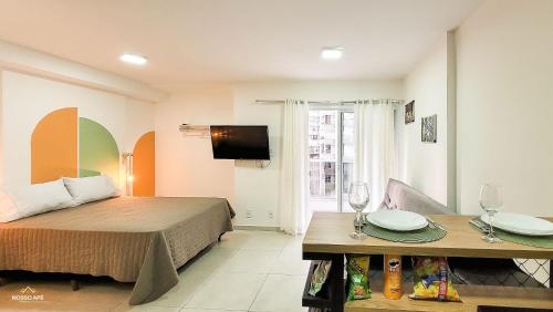 een hotelkamer met een bed en een tafel met borden erop bij Nosso Apê 915: Piscina | Academia | Área Kids NA0820 in Juiz de Fora