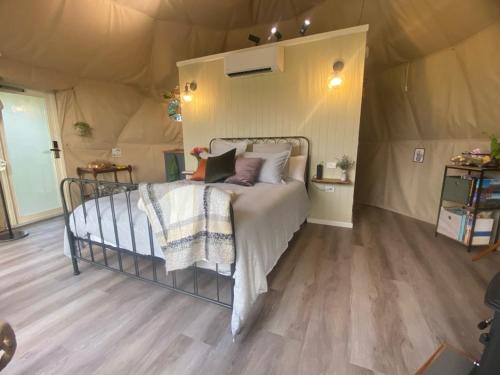a bedroom with a bed in a tent at Counting Stars in Yarragon
