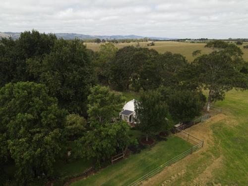 an overhead view of a white house in the trees at Counting Stars in Yarragon
