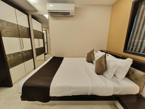 a bedroom with a large bed in a room at The Majlis Hotel - Colaba Mumbai in Mumbai