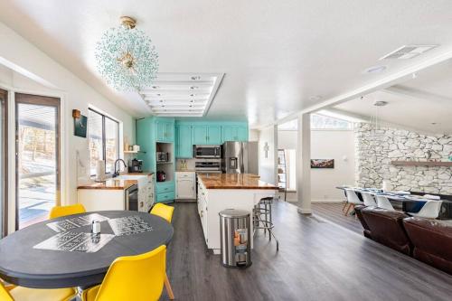 a kitchen and dining room with a table and yellow chairs at Modern LakeHouse Sleeps 20 Hot Tub/Games/Fire Pit in Oakhurst