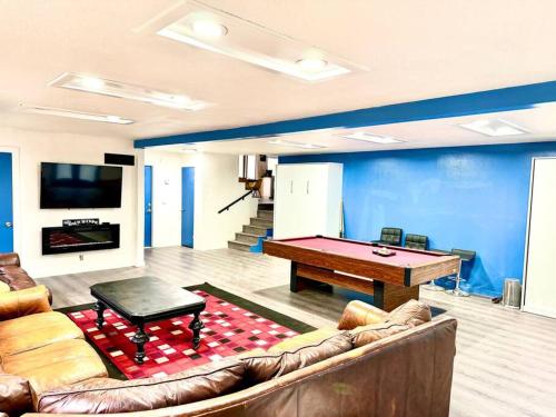 a living room with a couch and a pool table at Modern LakeHouse Sleeps 20 Hot Tub/Games/Fire Pit in Oakhurst