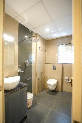 ein Badezimmer mit Waschbecken, Toilette und Dusche in der Unterkunft THE EKAH COMFORTS in Bangalore