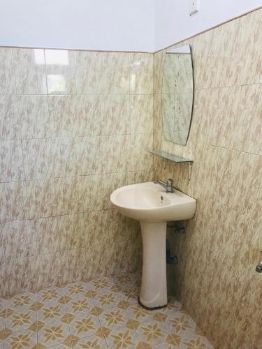 a bathroom with a sink and a mirror at Sun Shine House in Matara