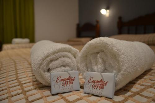 a pile of towels sitting on top of a bed at Encanto Del Mar in Ostende