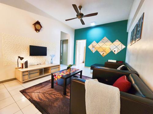 a living room with a couch and a tv at Klang Prima Bayu Cozy 4-Room Retreat in Klang