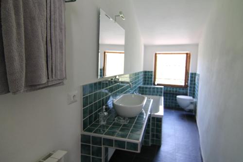 a bathroom with two sinks and a mirror at 5 Lands Stone Cottage in Levanto