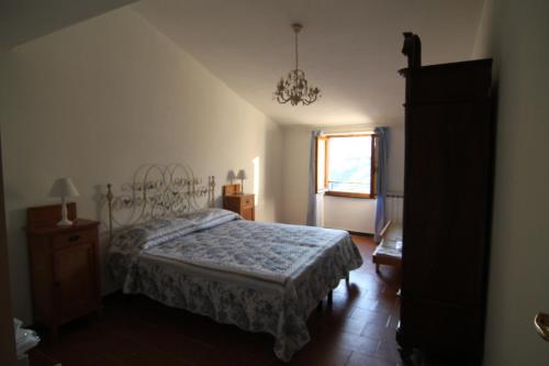 a bedroom with a bed and a dresser and a window at 5 Lands Stone Cottage in Levanto