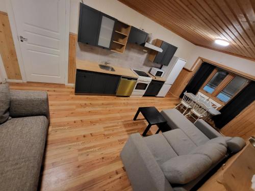 a living room with a couch and a table at One Bedroom Apartment Kjeller Lillestrøm - 2 mins from OSLOMET in Lillestrøm