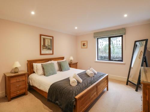 a bedroom with a bed and a window at Gillybeck in Ambleside