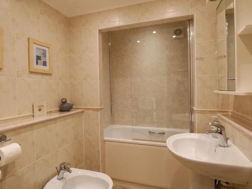 a bathroom with a sink and a toilet and a shower at Gillybeck in Ambleside