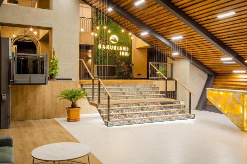 a lobby of a shopping mall with stairs and tables at Bakuriani Inn A112 in Bakuriani