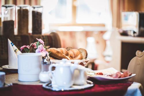 a table with a plate of bread and a cup of coffee at Pension Sonnenheim in Schönberg im Stubaital