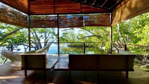 a glass house with a view of the water at Villa Luzo in Saonek