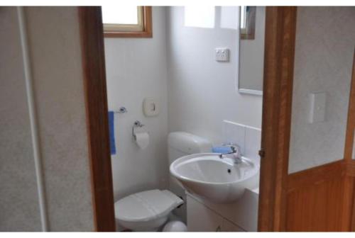 a bathroom with a white toilet and a sink at Discovery Parks - Kangaroo Island in Flinders Chase