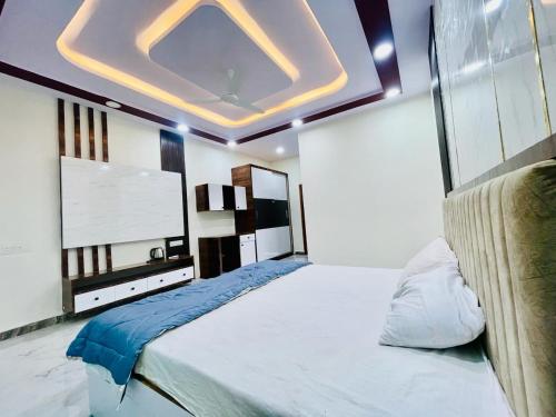 a bedroom with a large bed with a large screen at MPN RESORTS AND HOTELS PRIVATE LIMITED in Hyderabad