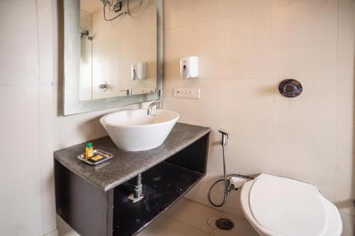 a bathroom with a sink and a toilet at Diamond Tree at Saket in New Delhi