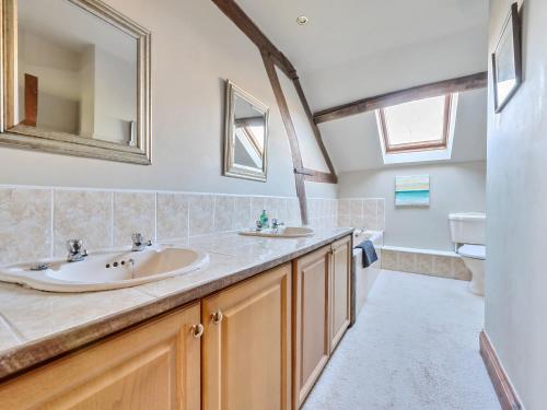 a bathroom with a sink and a mirror at The Chestnuts in Tenbury