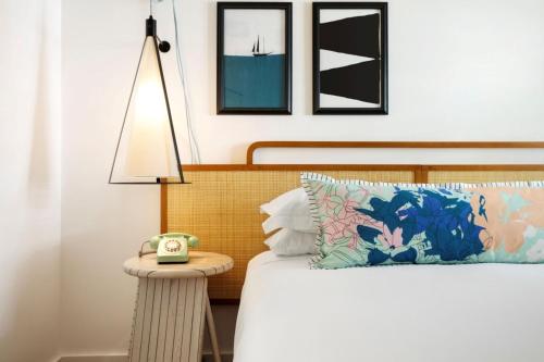a bedroom with a bed with a lamp on a table at Winslow's Bungalows - Key West Historic Inns in Key West