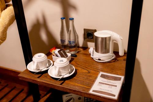 a table with tea cups and bottles on it at Anumana Ubud Hotel in Ubud