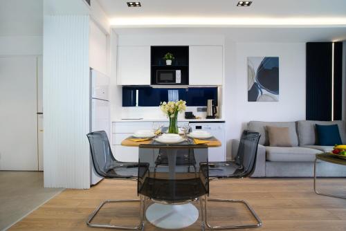 a dining room with a table and chairs in a living room at Stile Suite Marine Hotel in Antalya