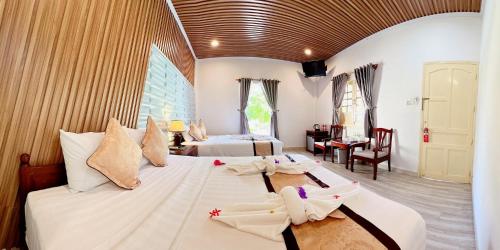 Postel nebo postele na pokoji v ubytování Malibu Resort