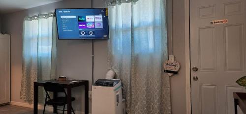 a room with a television and a table with a stool at Sweet Studio in Sarasota in Sarasota