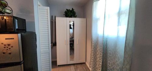 a bathroom with a mirror and a refrigerator at Sweet Studio in Sarasota in Sarasota