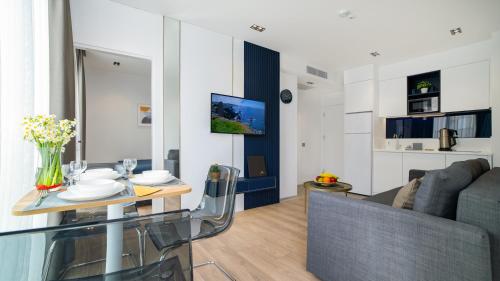 a living room with a table and a couch at Stile Suite Marine Hotel in Antalya