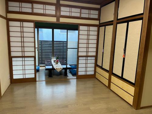 a room with japanese doors and a table in a building at 富士山世界文化遺産三保松原久能山東照宮日本観光地第一日本平体験日本文化貸切民泊韶光 in Shizuoka