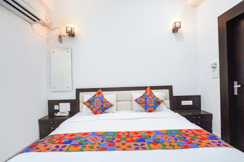 a bedroom with a bed with a colorful comforter at FabHotel KP Palace in Agra