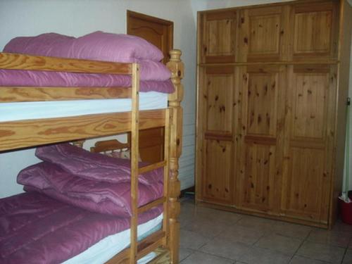 a bedroom with two bunk beds and a cabinet at Appartement 8 pers. avec vue montagne 70848 in Saint-Sorlin-dʼArves