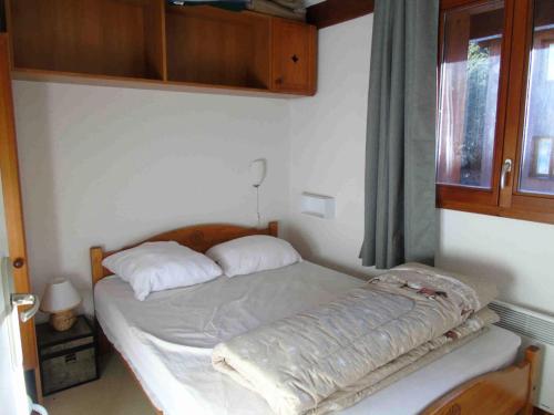 une chambre avec un lit avec une tête de lit en bois dans l'établissement Chalet Arrondaz - 2 Pièces pour 6 Personnes MAE-8694, à Modane