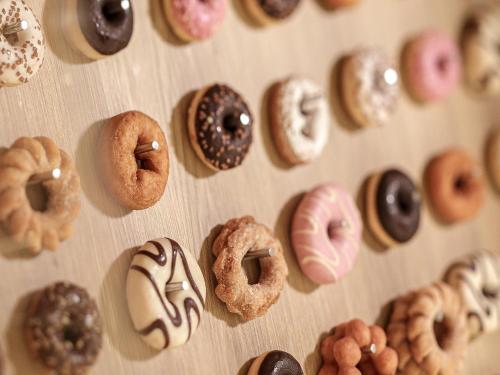 a bunch of donuts lined up on a wall at ORIENTAL HOTEL UNIVERSAL CITY in Osaka