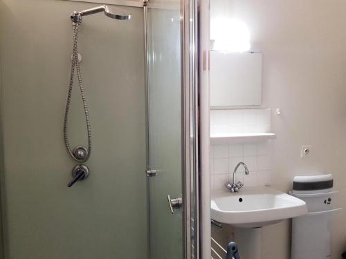 a bathroom with a shower and a sink at Gîte de France Gîte ecole 3 épis - Gîte de France 4 personnes 434 in Soursac