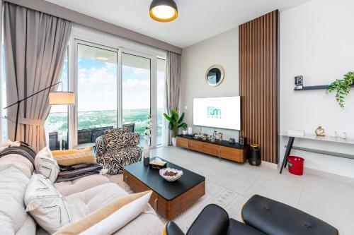 een woonkamer met een bank en een tv bij FAM Living - 2 Bedroom Home close to Dubai Frame in Dubai