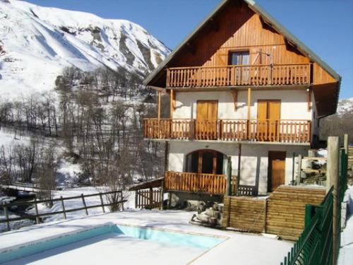 une maison avec un balcon et une piscine dans la neige dans l'établissement Appartement 4 pers. avec balcon vue montagne 70839, à Saint-Sorlin-dʼArves