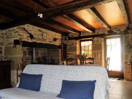a room with a large bed with blue pillows at Gîte de France Chez le garde 3 épis - Gîte de France 4 personnes MAE-8974 in Lanteuil