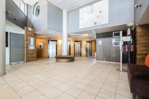 Cette grande chambre dispose d'un hall avec un canapé. dans l'établissement Résidence L'Ours Blanc - maeva Home - Studio 5 pers Confort MAE-5828, à Huez