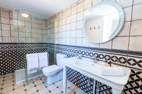 a bathroom with a sink and a toilet and a mirror at Gîte de France Le clos du bournazel 4 épis - Gîte de France 4 personnes 254 in Albignac