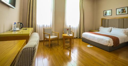 a hotel room with a bed and a desk at New Day Hotel in Addis Ababa