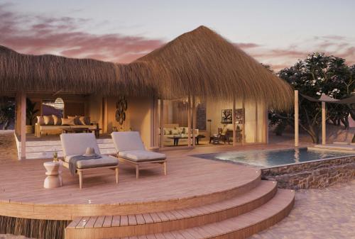 un resort con terrazza con sedie e piscina di Bawe Island Zanzibar a Stone Town