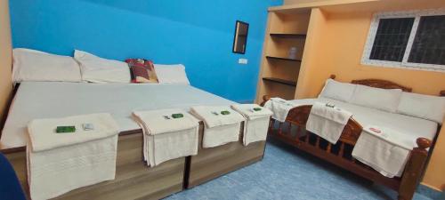 a bedroom with two beds with towels on them at Pushpa Mahal A/C & Pushpa Residency in Tiruvannāmalai