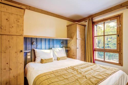 une chambre avec un lit et une fenêtre dans l'établissement Résidence Les Arcs 1950 Le Village - maeva Home - Appartement 3 pièces 6 personnes Selection MAE-1630, à Bourg-Saint-Maurice