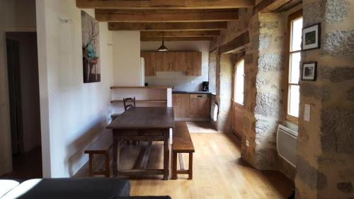 a kitchen with a wooden table in a room at Gîte de France Maison raymond 3 épis - Gîte de France 12 personnes MAE-9804 in Saint-Angel