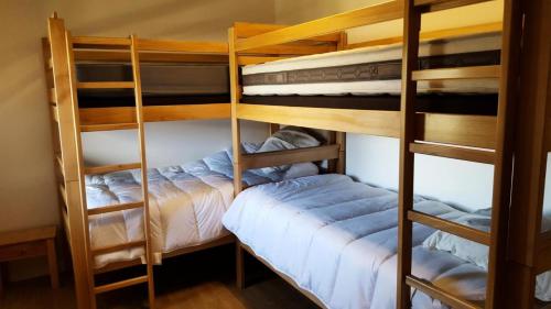 two bunk beds in a room with a bed at Gîte de France Maison raymond 3 épis - Gîte de France 12 personnes MAE-9804 in Saint-Angel