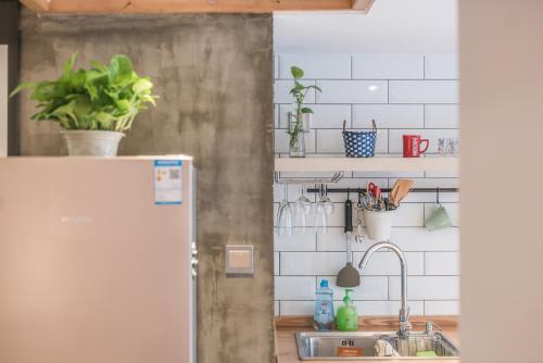 a kitchen with a sink and a refrigerator at Shanghai Hills&XING 1883 Homestay in Shanghai