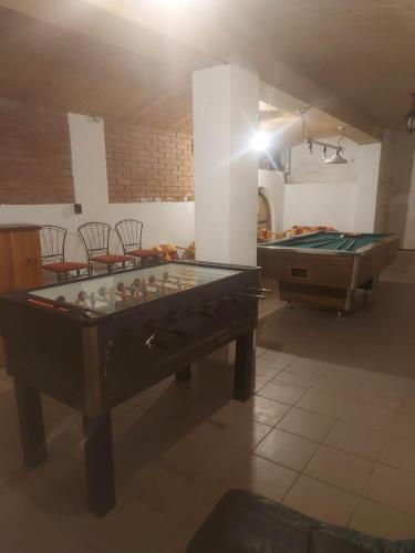 a room with a table and two pool tables at Attila's Guest House in Budaörs
